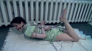 Hogtied and gagged brunette struggling on the floor