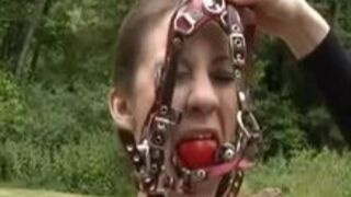 Caged naked outdoors