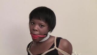 black strapped up and gagged in chair