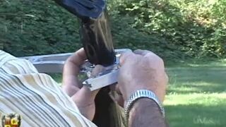 Jewell in Latex Hood and Metal Cuffs Outdoors