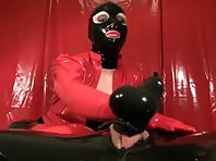 Latex Mistress giving a footjob for man with tied balls